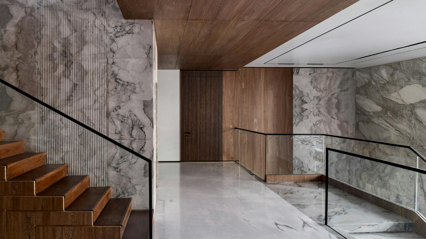 Modern interior with marble and wood-textured architectural finishes on the walls and ceiling